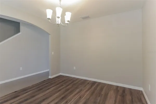 a view of wooden floor and chandelier in a room