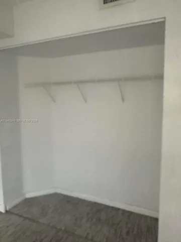 a bathroom with a granite countertop sink a toilet and a mirror