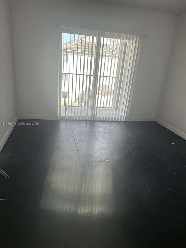 15460 Southwest 284th Street, Unit 4301 Homestead, FL 33033 - Photo 5 of 17 a view of an empty room with a window