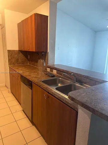 a bathroom with a granite countertop sink a toilet and a mirror