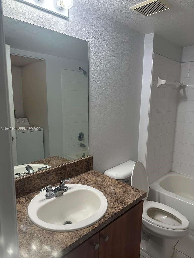 15460 Southwest 284th Street, Unit 4301 Homestead, FL 33033 - Photo 9 of 17 a bathroom with a granite countertop sink a toilet and a mirror