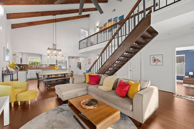 a living room with furniture kitchen view and a dining table