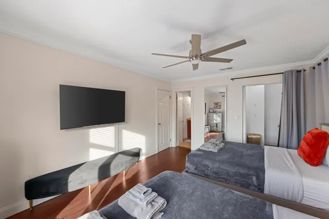 a bedroom with a bed and a flat screen tv