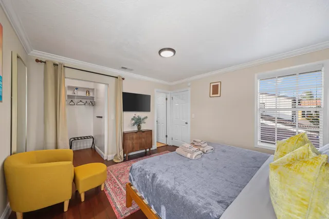 a bedroom with a bed and wooden floor