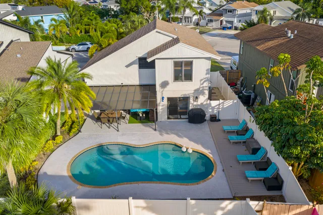 a view of a swimming pool with a yard