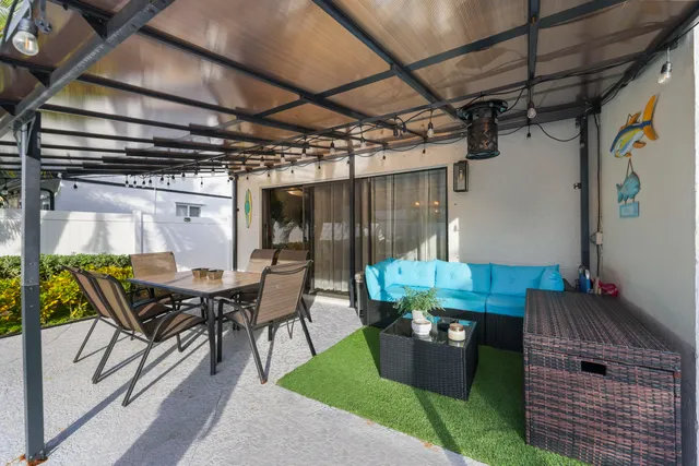 a view of a patio with a table and chairs