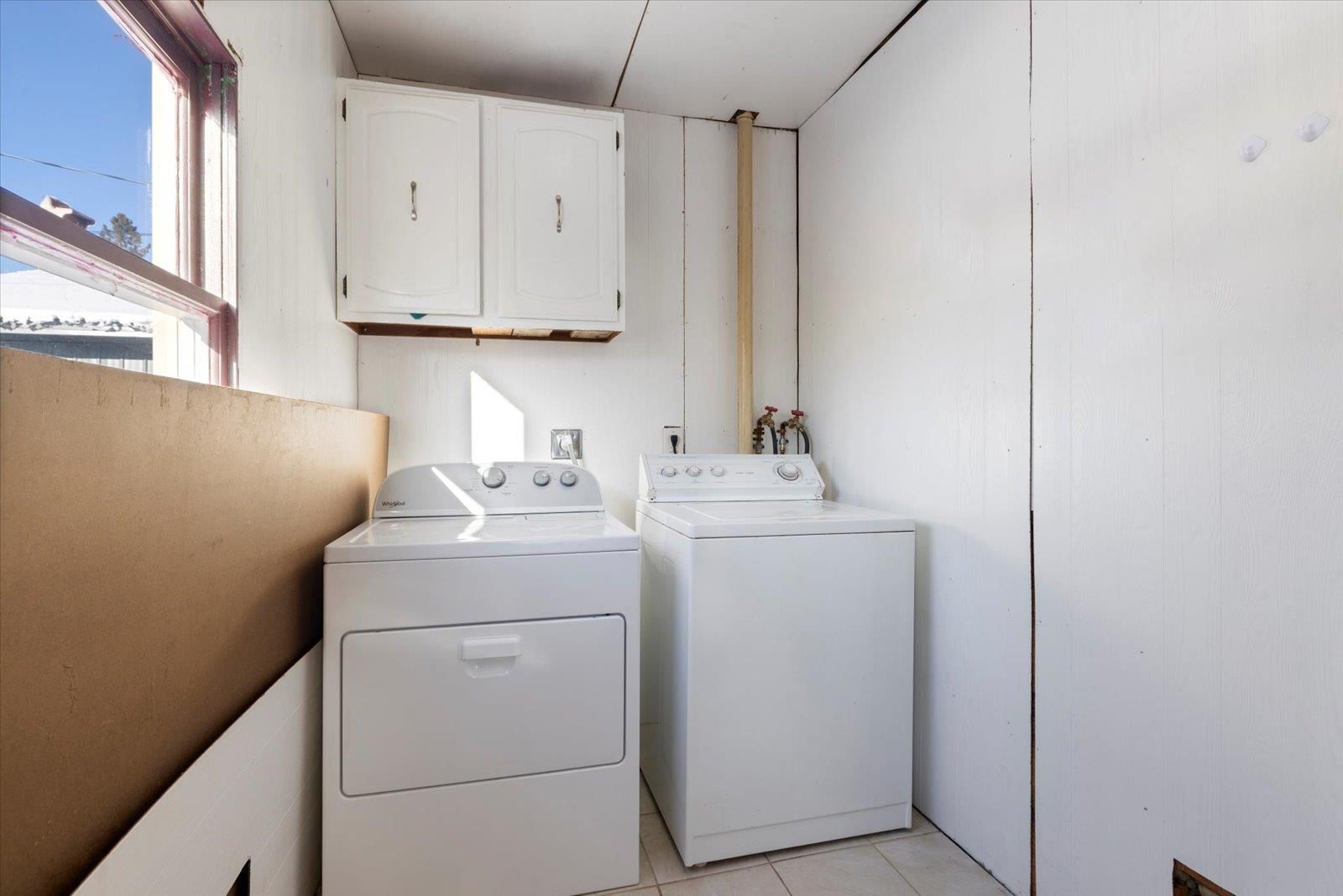 24 Fern Court Babbitt, MN 55706 - Photo 16 of 41 Laundry room featuring separate washer and dryer, light tile patterned floors, and cabinet space