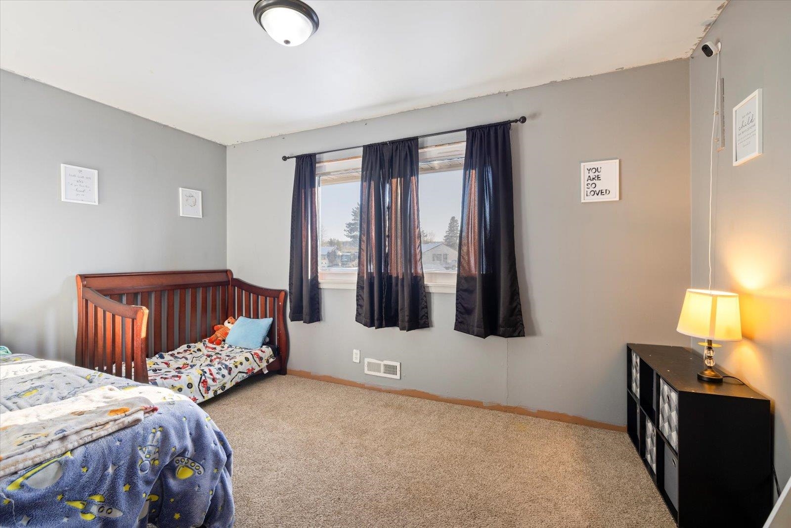 24 Fern Court Babbitt, MN 55706 - Photo 23 of 41 Bedroom with light carpet and baseboards