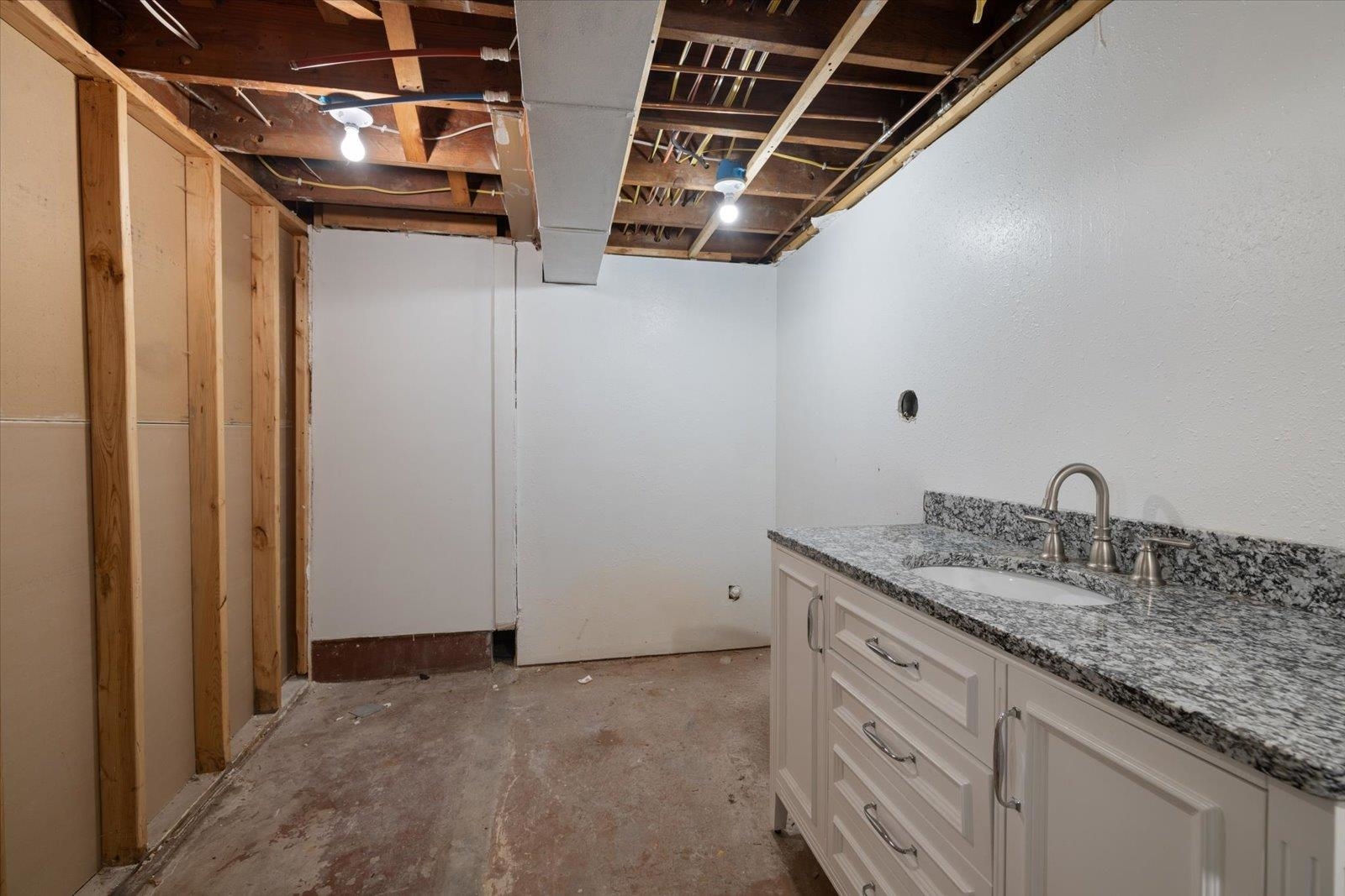 24 Fern Court Babbitt, MN 55706 - Photo 33 of 41 Bathroom with vanity and unfinished concrete floors