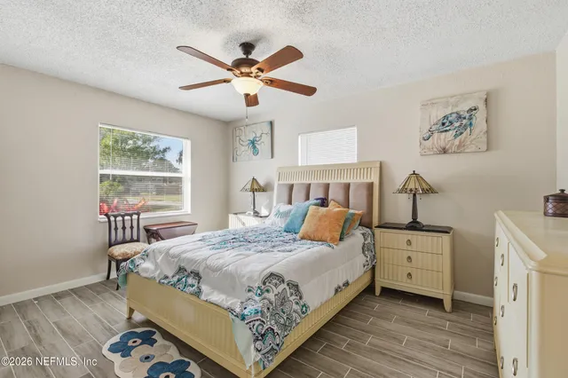 a bedroom with a large bed and a window