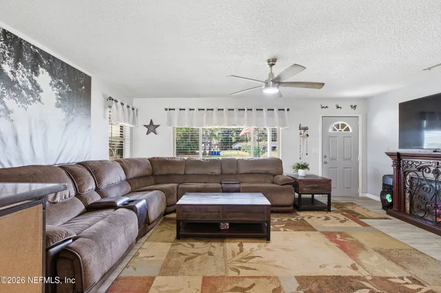 a living room with furniture and a flat screen tv