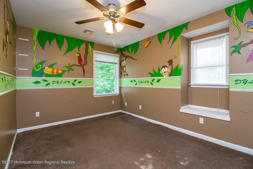 799 Leonardville Road Leonardo, NJ 07737 - Photo 14 of 25 an empty room with windows and a ceiling fan