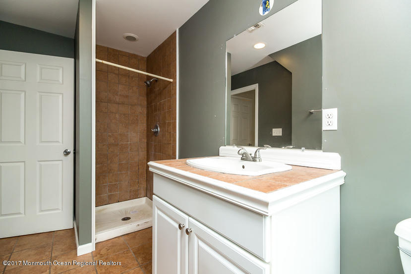 799 Leonardville Road Leonardo, NJ 07737 - Photo 17 of 25 a bathroom with a sink and a mirror
