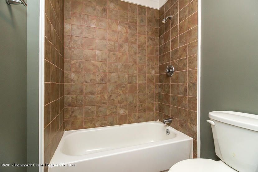 799 Leonardville Road Leonardo, NJ 07737 - Photo 18 of 25 a white bath tub sitting next to a white toilet