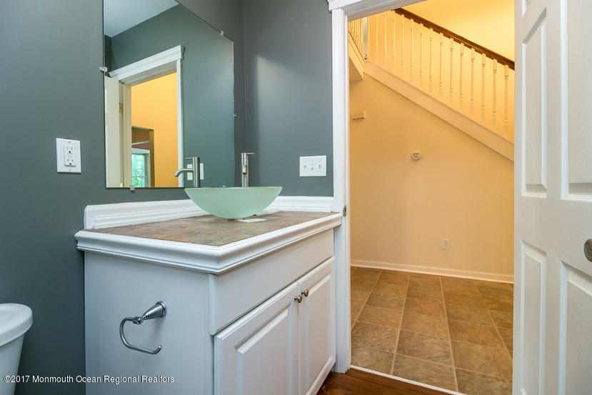 799 Leonardville Road Leonardo, NJ 07737 - Photo 20 of 25 a bathroom with a granite countertop sink and a mirror
