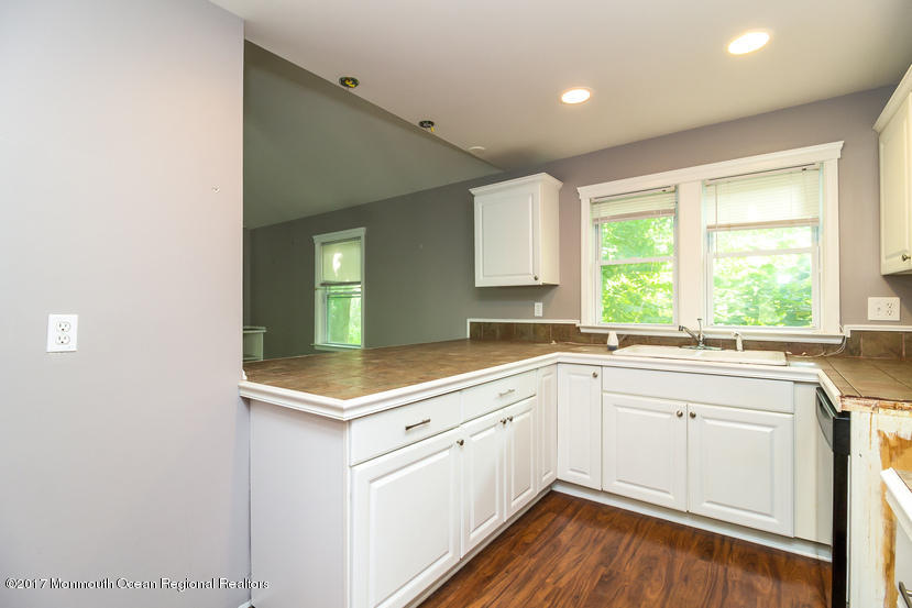 799 Leonardville Road Leonardo, NJ 07737 - Photo 10 of 25 a kitchen with a sink window and cabinets