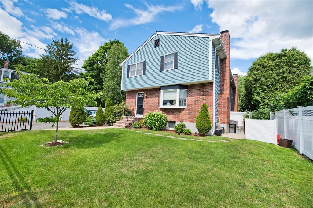 16 Warren Avenue Newton, MA 02465 - Photo 1 of 42 a front view of a house with a garden