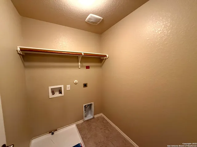 an empty room with windows and mirror