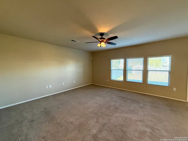 an empty room with a empty space and windows