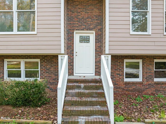 a view of a house with more windows and brick walls
