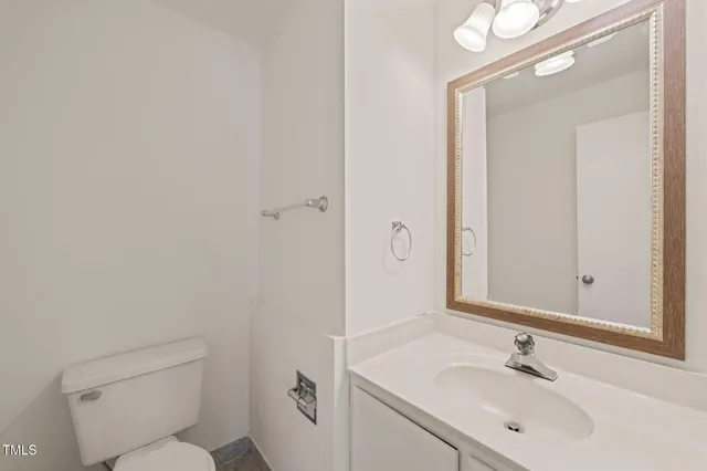 a bathroom with a sink toilet and vanity