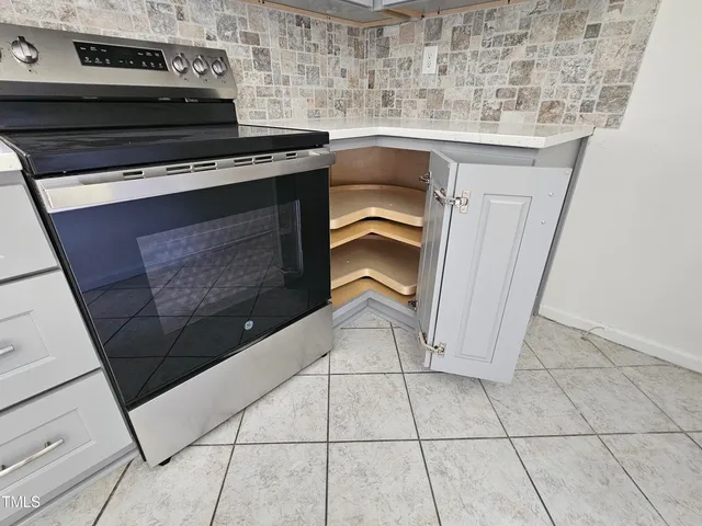 a stove top oven sitting inside of a kitchen