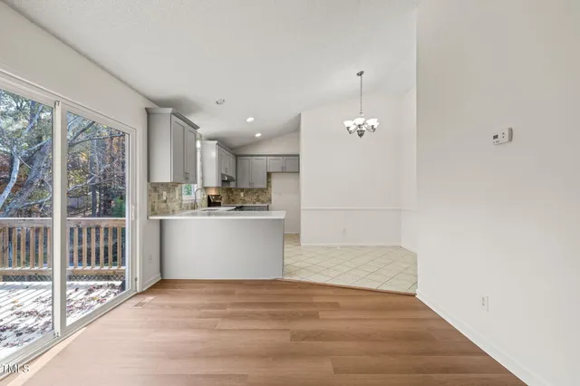 a view of a kitchen with wooden floor and a kitchen