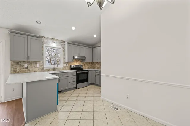 a kitchen with a sink window and cabinets