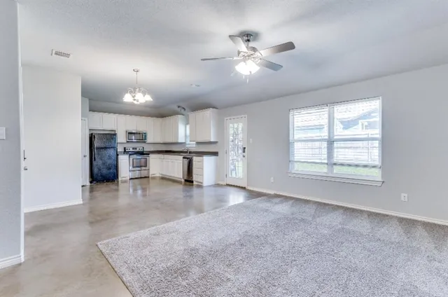 a view of a kitchen with a stove cabinets and a kitchen
