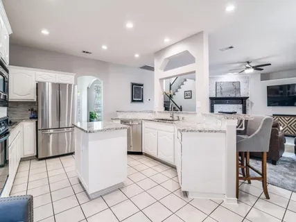 a kitchen with a sink cabinets and stainless steel appliances