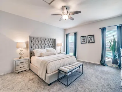 a bedroom with a bed and a chandelier