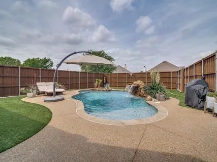 a view of a backyard with sitting area and entertaining space