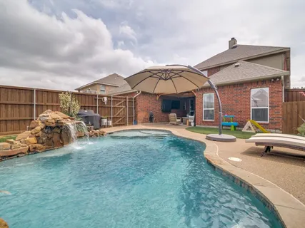 a view of a house with swimming pool and porch