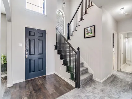 a view of entryway and hall with wooden floor