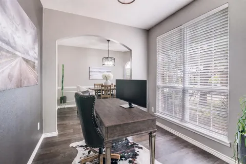 a view of a dining room with furniture and a window