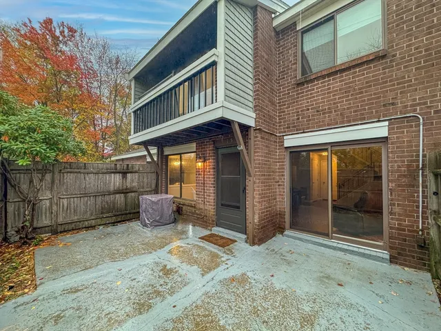 a backyard of a house with barbeque oven table and chairs