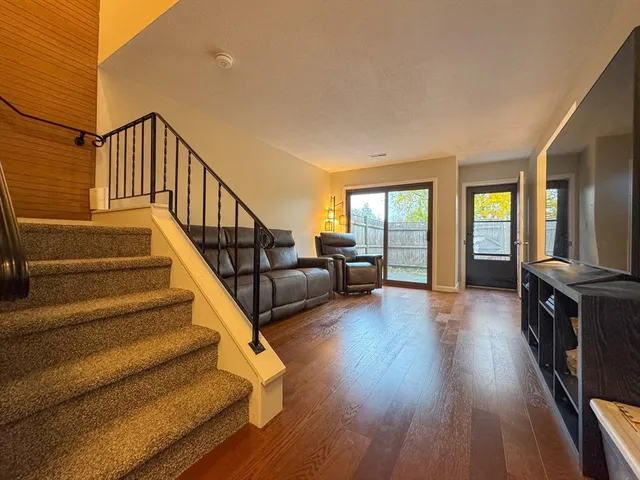 a view of entryway and hall with wooden floor