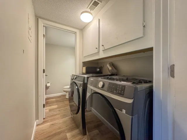 a view of washer and dryer with kitchen in the background