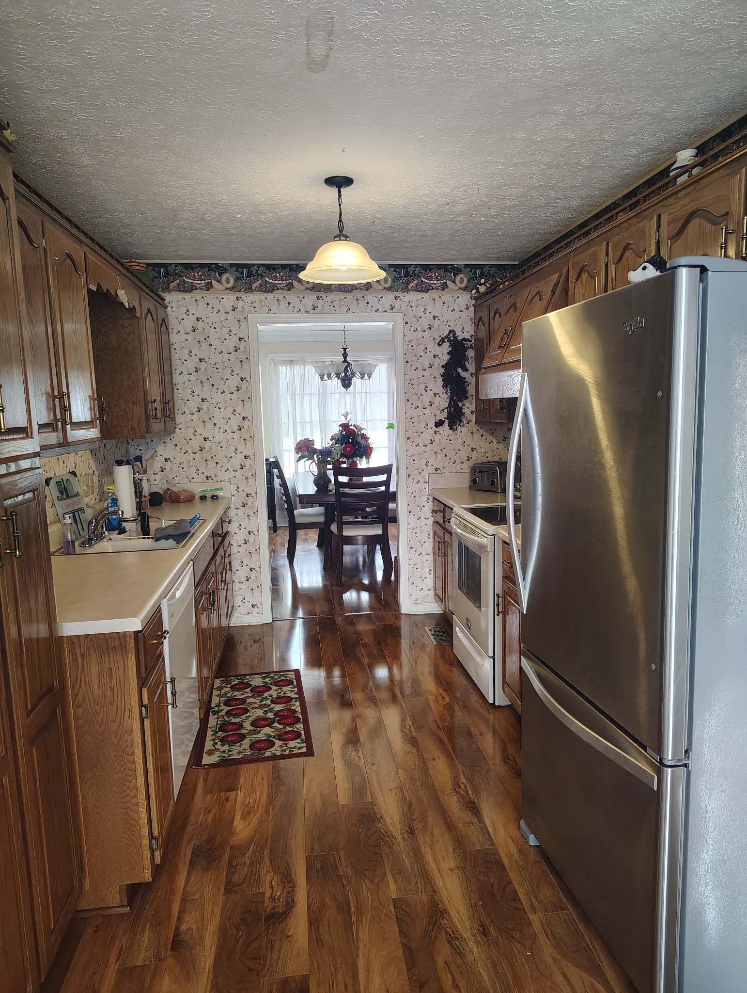 29 Bluebird Lane Lafayette, TN 37083 - Photo 9 of 17 a kitchen with granite countertop a refrigerator a sink a stove and chairs