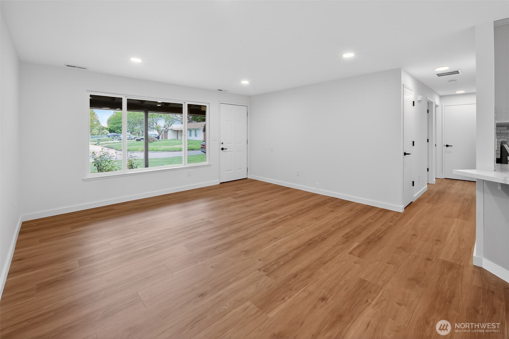 320 213th Place Southwest Bothell, WA 98021 - Photo 9 of 29 a view of an empty room with wooden floor and a window
