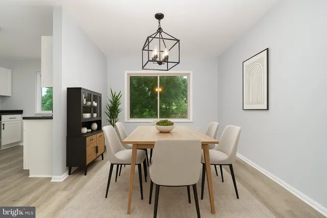a view of a dining room with a table and chairs