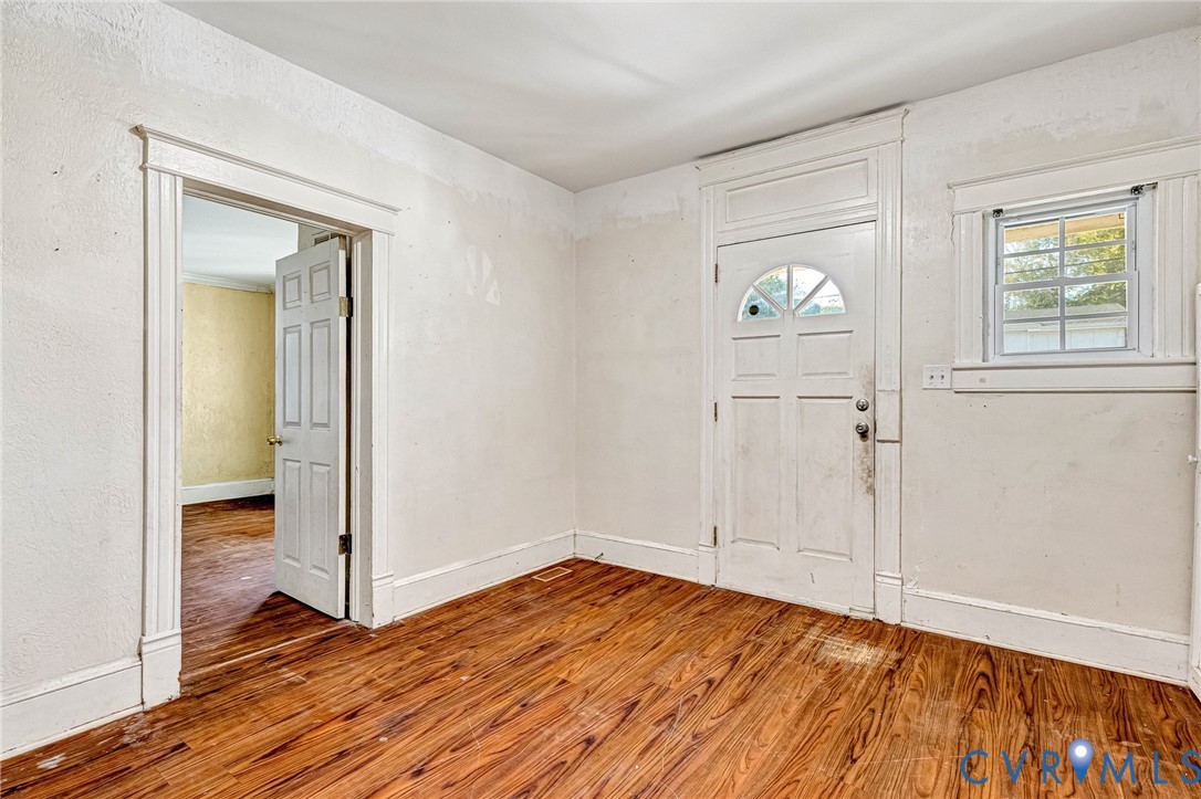 3301 Main Street Petersburg, VA 23803 - Photo 3 of 18 an empty room with wooden floor mirror and windows