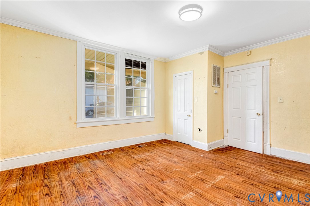 3301 Main Street Petersburg, VA 23803 - Photo 5 of 18 a view of an empty room with wooden floor and a window