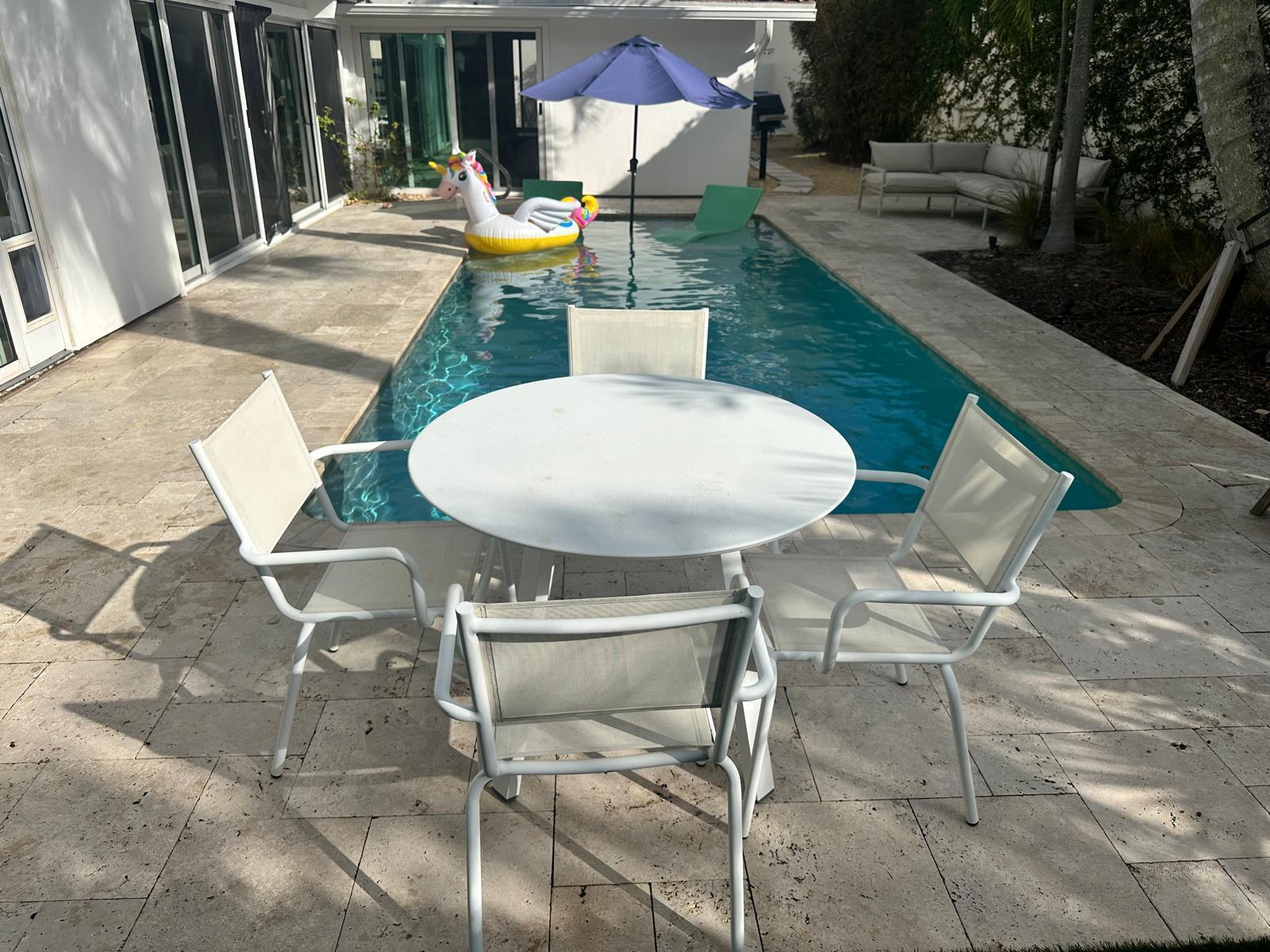 Undisclosed Address Jupiter, FL 33477 - Photo 104 of 107 a view of a patio with table and chairs potted plants with wooden floor