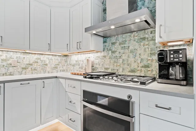 a large bed sitting in a bedroom next to a large window