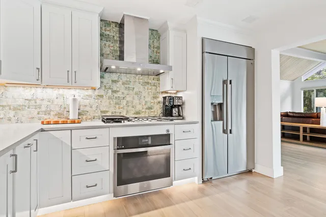 a bedroom with a bed mirror and a window