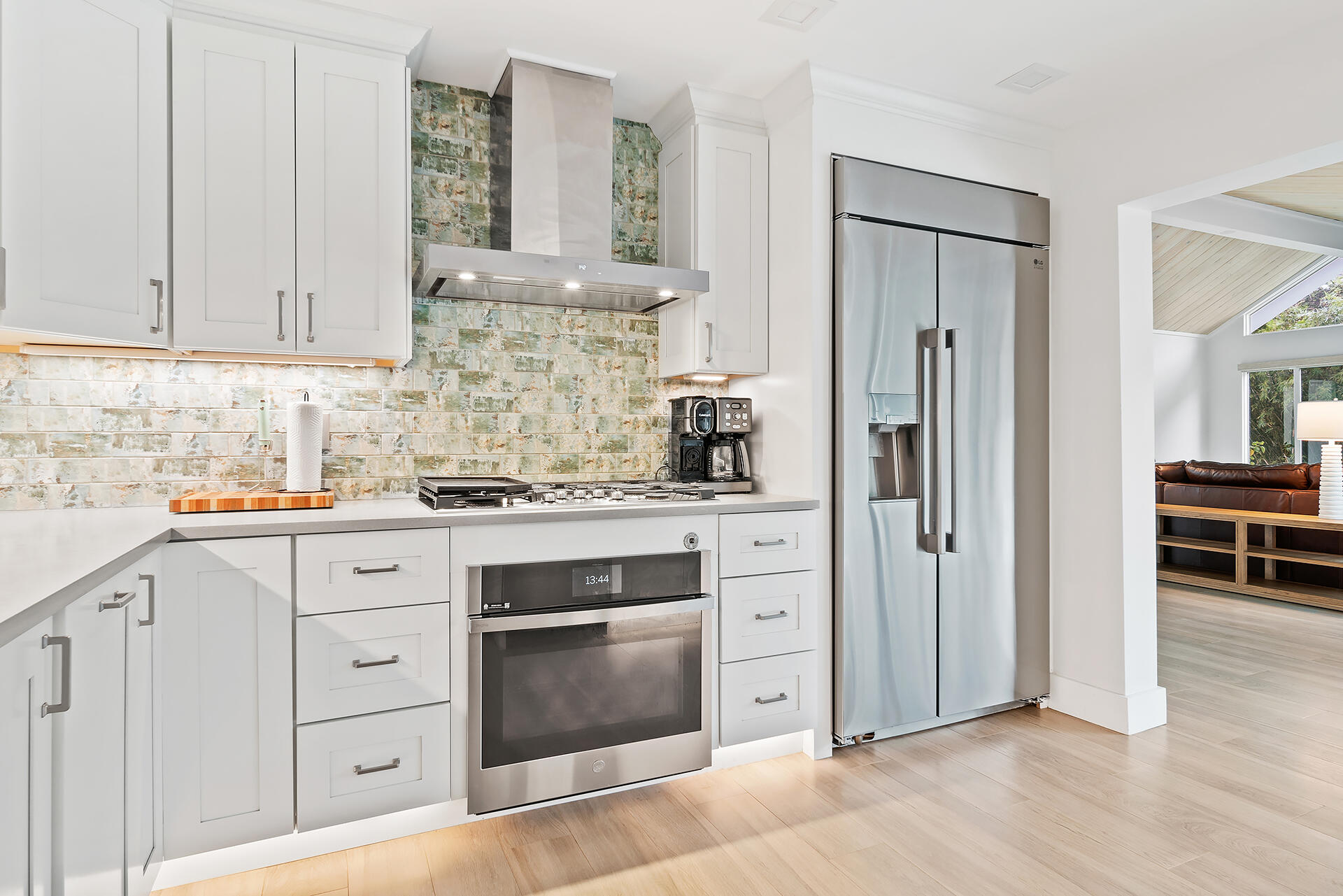 Undisclosed Address Jupiter, FL 33477 - Photo 15 of 107 a kitchen with white cabinets and stainless steel appliances