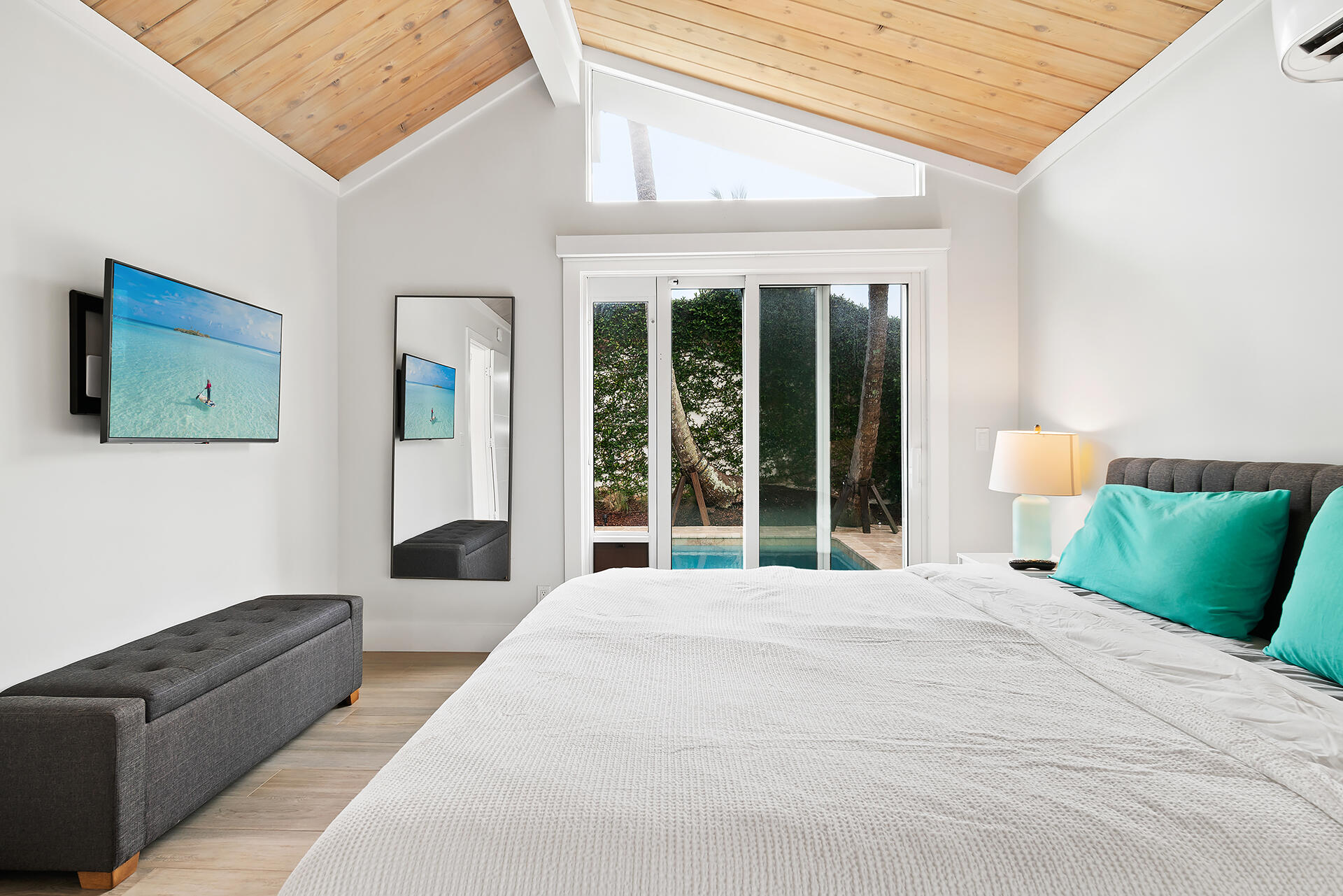 Undisclosed Address Jupiter, FL 33477 - Photo 17 of 107 a large bed sitting in a bedroom next to a large window