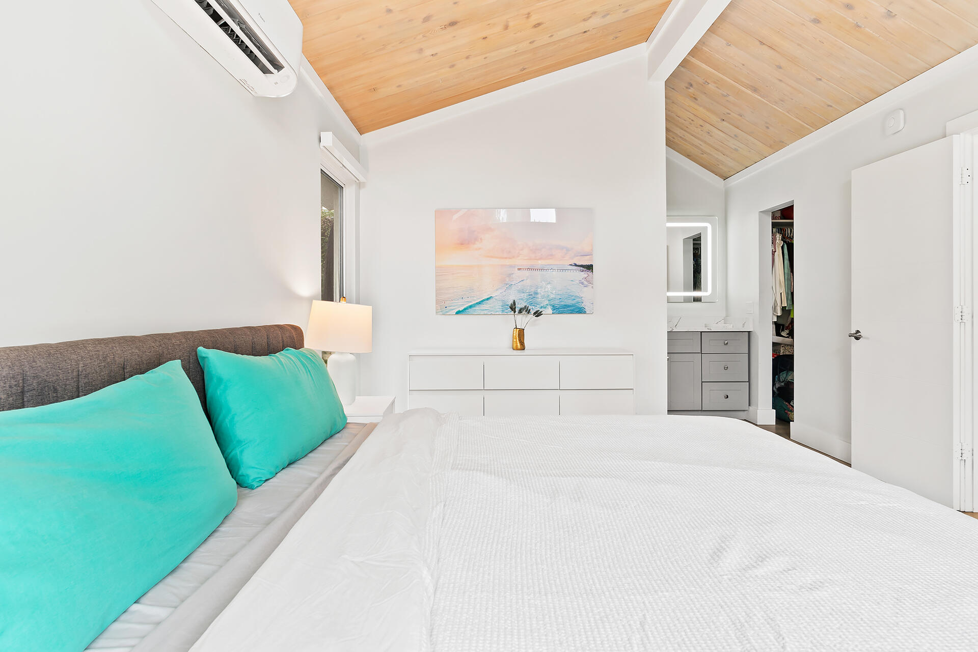 Undisclosed Address Jupiter, FL 33477 - Photo 18 of 107 a bedroom with a bed mirror and a window