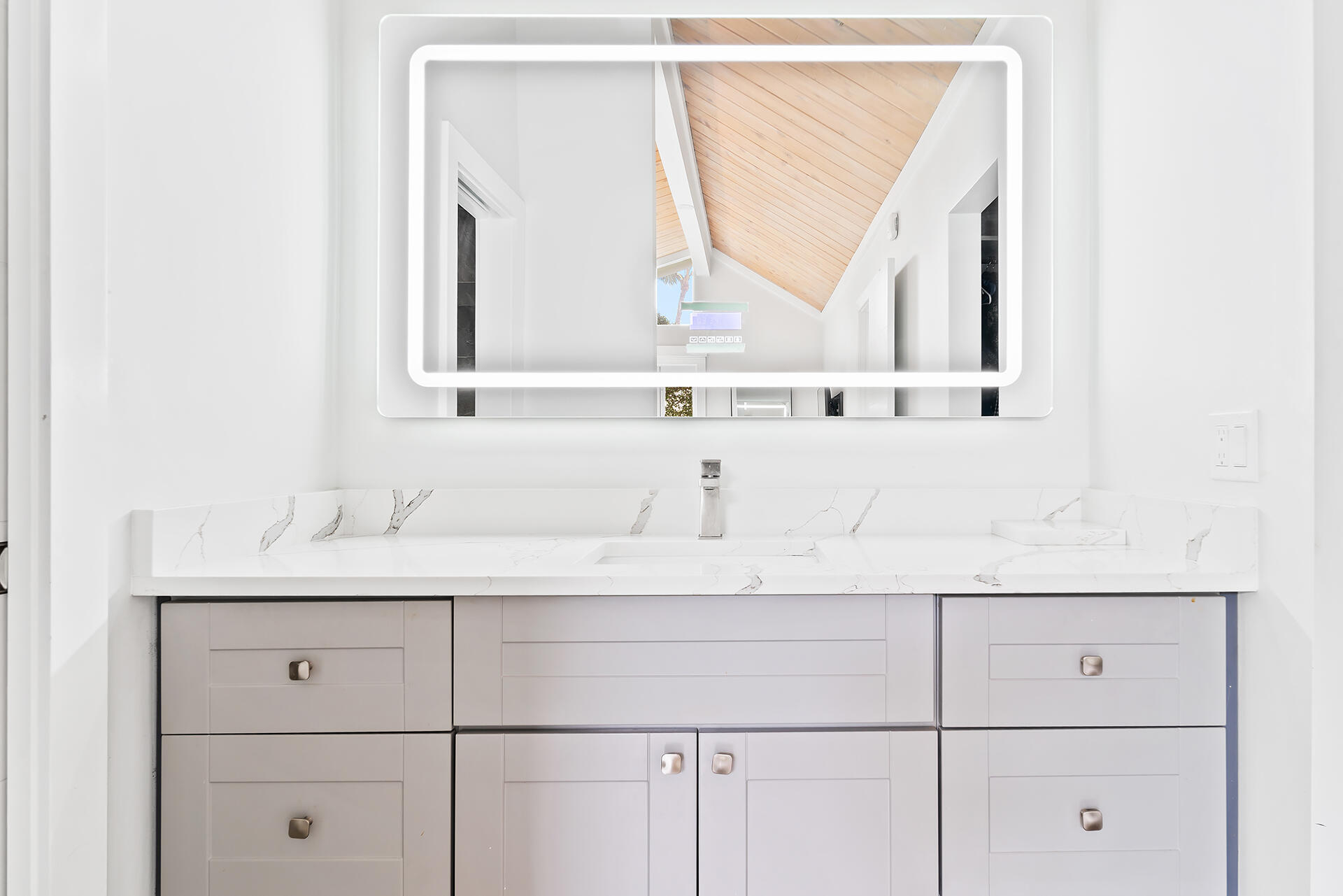 Undisclosed Address Jupiter, FL 33477 - Photo 19 of 107 a bathroom with a sink and a mirror